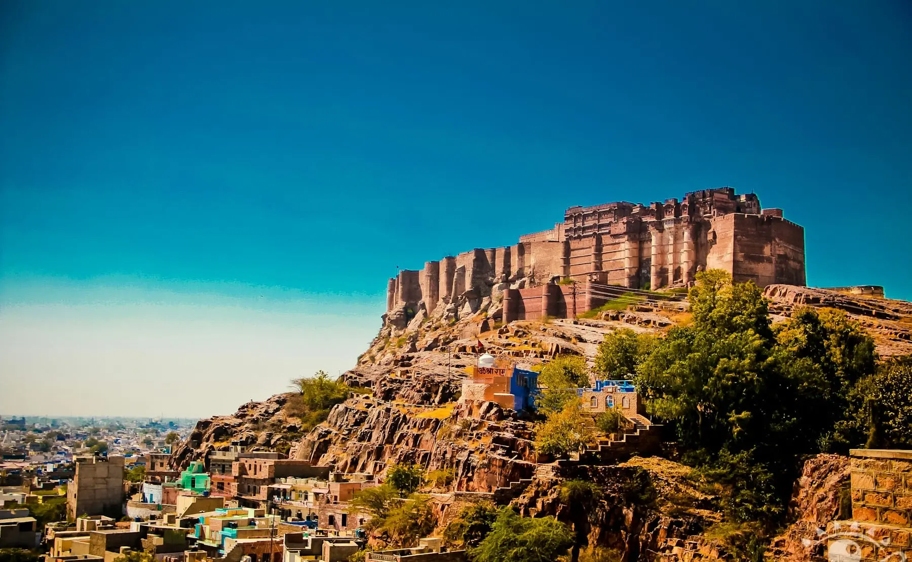 Mehrangarh Fort on its rocky ridge above Jodhpur's houses under a deep blue sky