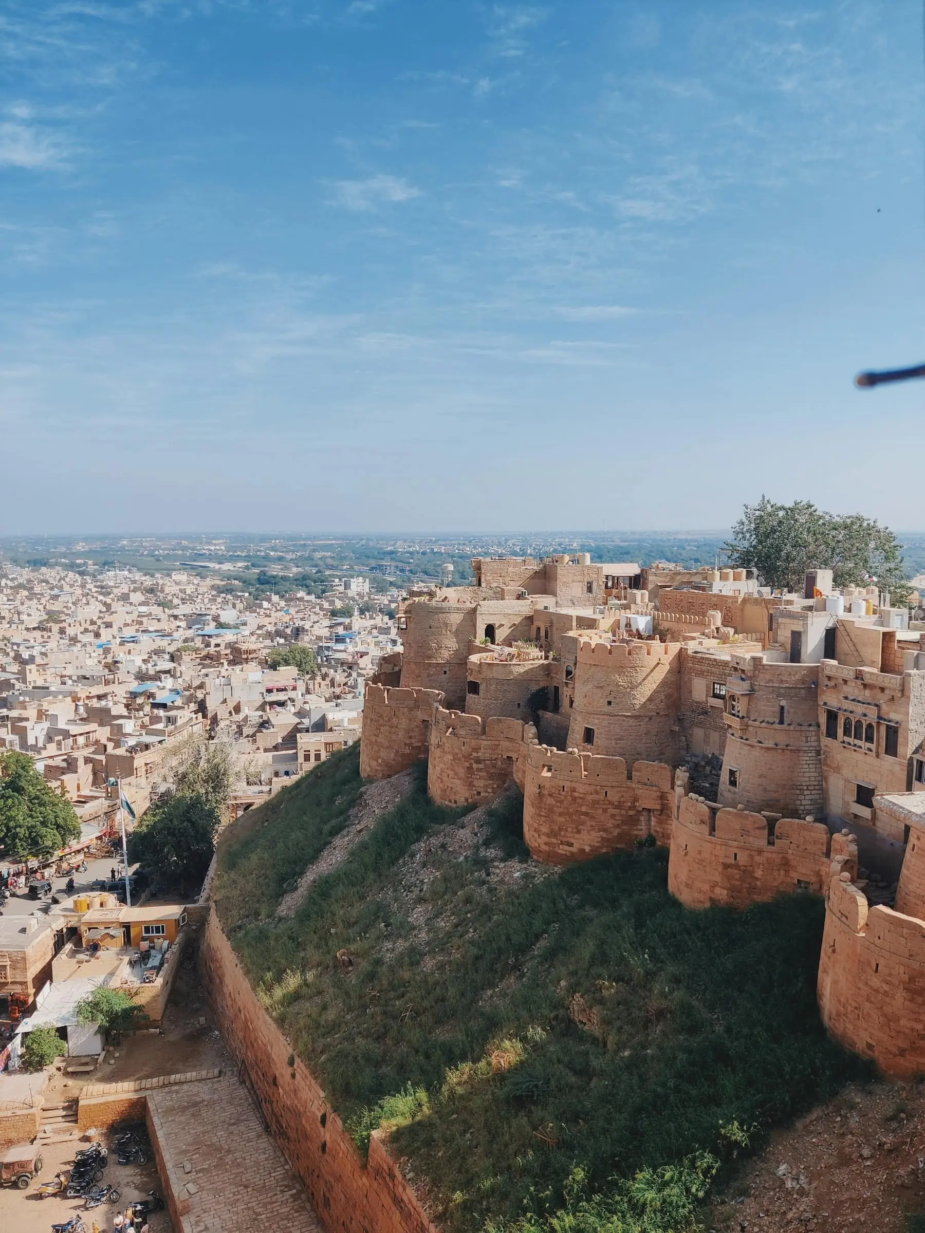 Golden sandstone walls and bastions of Jaisalmer Fort on its hill above the town