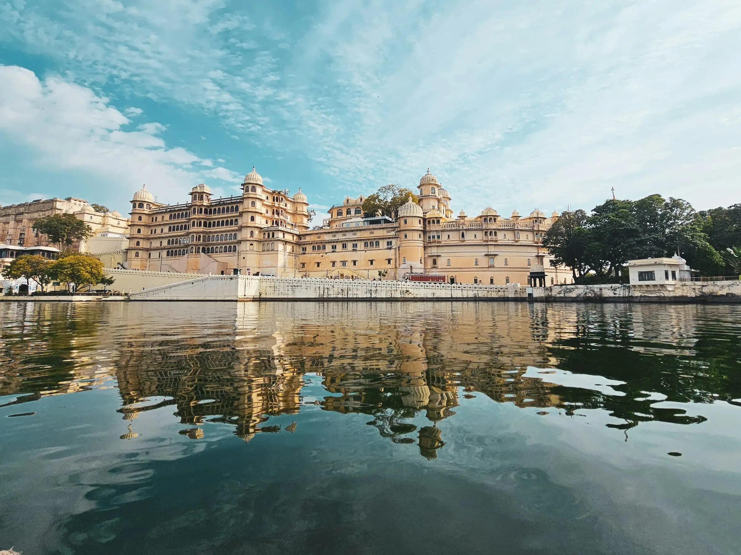 Udaipur's City Palace along the shore of Lake Pichola, reflected in the still water